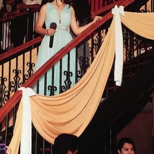 It’s a prom turquoise or light blue dress.